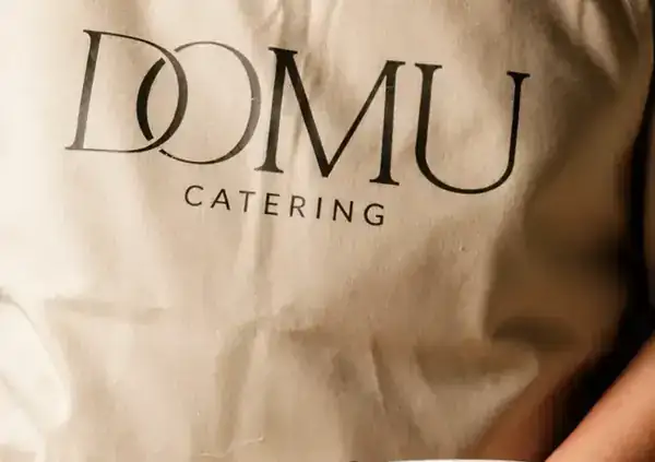 Dessert served by a Domu chef in a branded apron