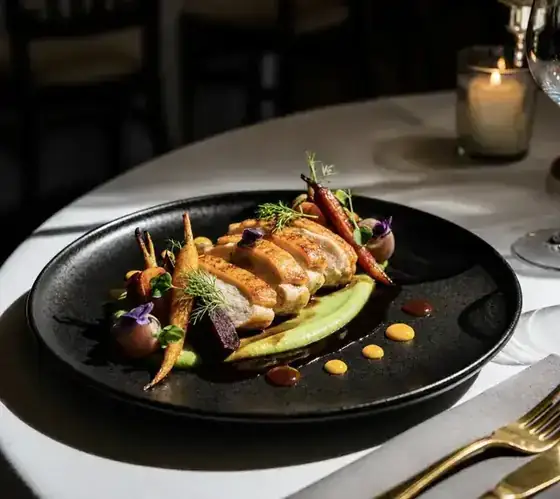 Corn fed chicken plated on black